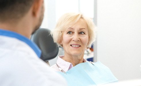 patient smiling while looking at dentist